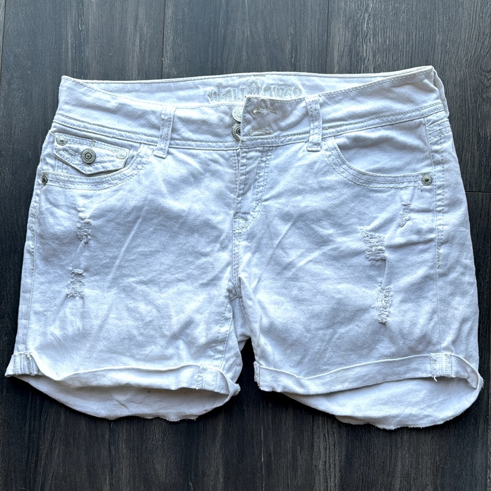 Distressed white jean shorts